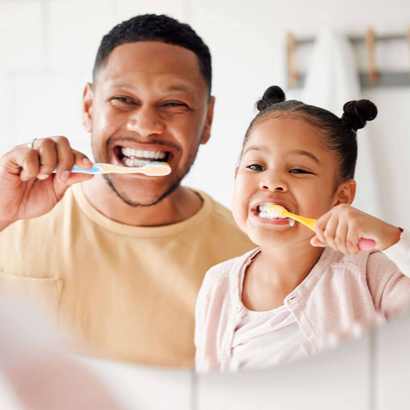 Dad and Daugher brushing teeth