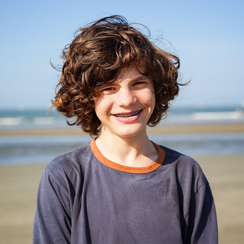 kid with braces at beach